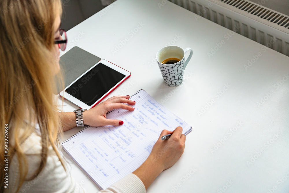 Girl studying at home with tablet and notebook Girl studying at home with tablet and notebook
