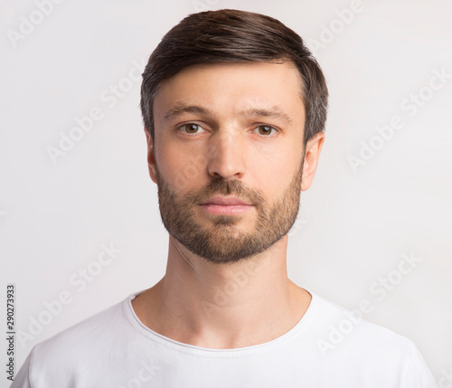 Portrait Of Man Looking At Camera Over White Background