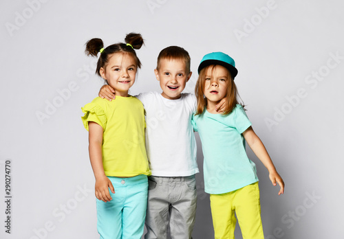 Studio Portrait Of Children On A Light Background Full Body Shot Of Three Children In Bright Clothes Two Girls And One Boy Triplets Brother And Sisters Stock Photo Adobe Stock