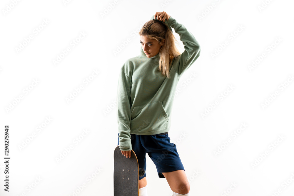 Naklejka premium Blonde teenager skater girl over isolated white background