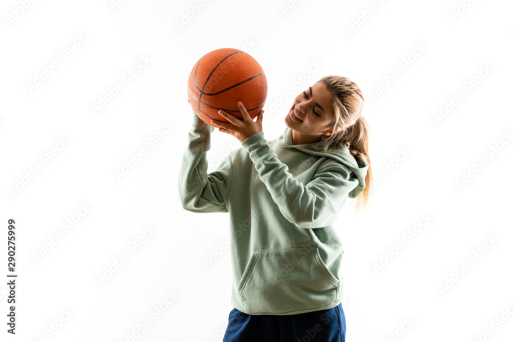 Teenager girl playing basketball over isolated white background Teenager girl playing basketball over isolated white background