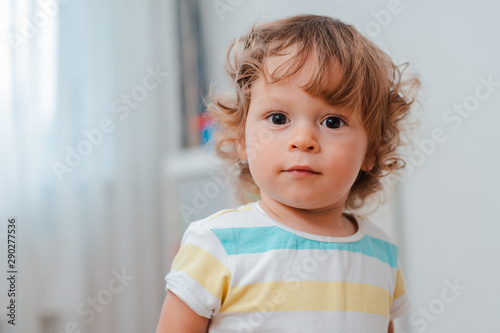close-up of baby's face, cute baby with curly hair. Portrait of a
