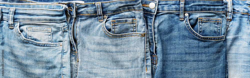 Flat lay collection of fashionable blue jeans, border. Top view, banner.