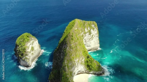 Drone Shot by drone Ocean with waves and rocky clif fBali, Indonesia. Aerial view of Big Blue Sea Wave viewpoint. Beautifulbeach of Kelingking in Nusa Penid. photo