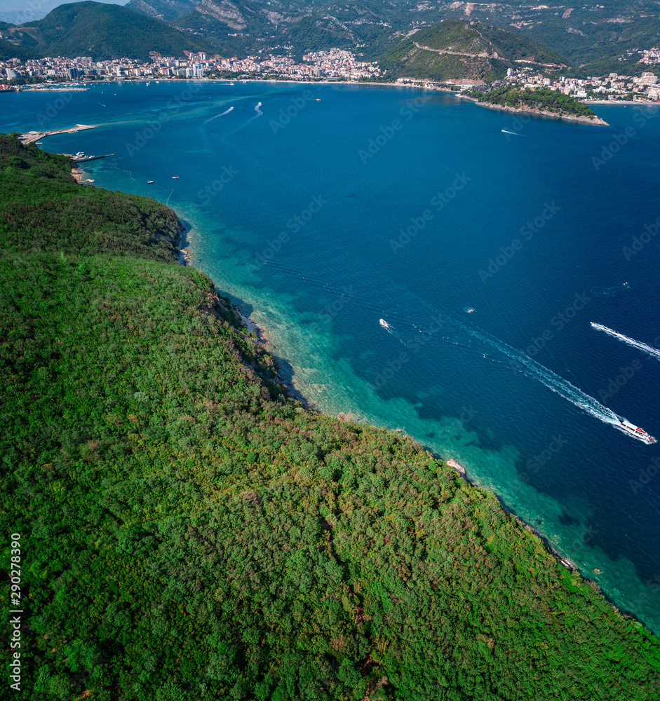 Aerial view of Sveti Nikola, Budva island, Montenegro. Jagged coasts with sheer cliffs overlooking the transparent sea. Wild nature and Mediterranean maquis