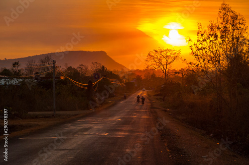 Motorbike driving on scenic road in sunset, Laos