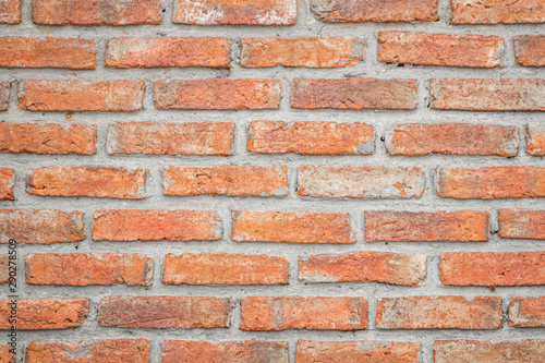 Orange brick wall concrete or stone texture background, wallpaper limestone abstract to flooring and homework/Brickwork or stonework clean grid uneven interior rock old.