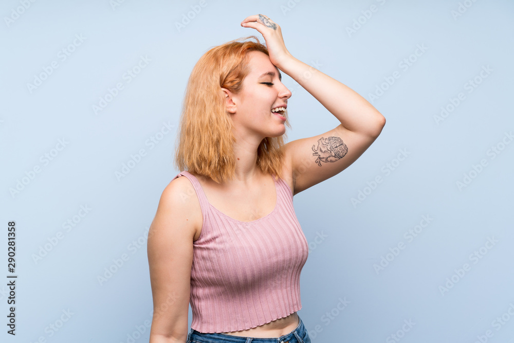 Young woman over isolated blue background has realized something and intending the solution