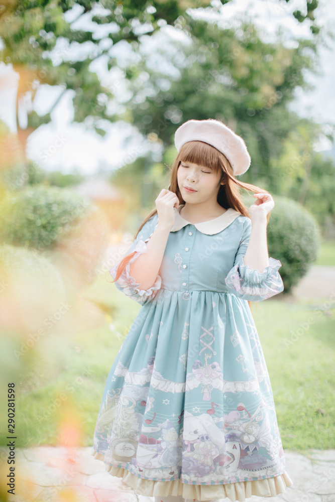 Portrait of asian girl in lolita fashion dress in garden background