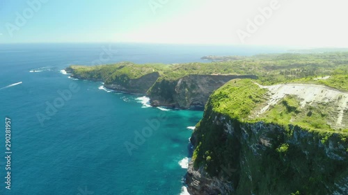 Aerial view of Big Blue Sea Wave viewpoint. Beautifulbeach of Kelingking in Nusa Penid.  Drone Shot by drone Ocean with waves and rocky cliff Bali, Indonesia. photo