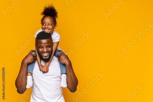 Happy african american father and daughter having fun