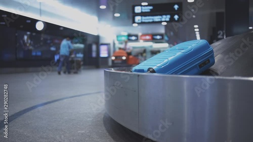 Baggage reclaim at the airport, travellers picking their luggages from the belt after arrival