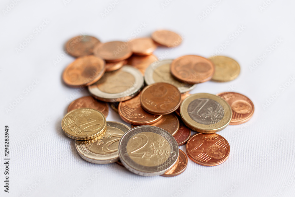 Various euro coins on white cloth. Money concept. Finance concept. Various euro coins on white cloth. Money concept. Finance concept.
