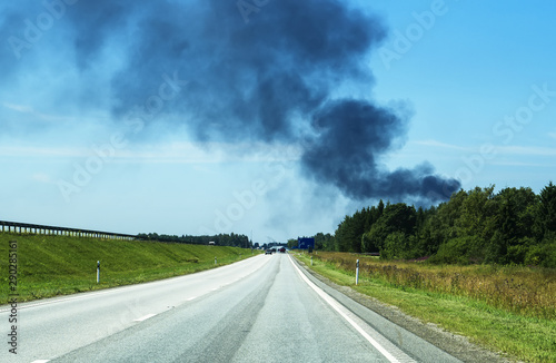 A big fire in the forest near the highway. © M-Production