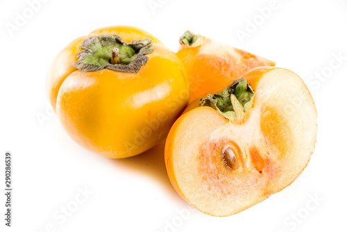 Whole and sliced persimmons  fresh organic farm fruit on a white background. Isolated  copy space