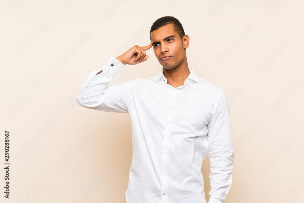 Young handsome brunette man over isolated background making the gesture of madness putting finger on the head Young handsome brunette man over isolated background making the gesture of madness putting finger on the head