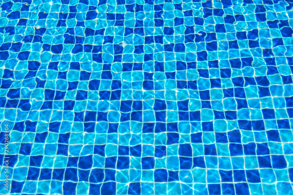 Blue ceramic floor in swimming pool with ripple wave water and sun reflection in background concept Blue ceramic floor in swimming pool with ripple wave water and sun reflection in background concept