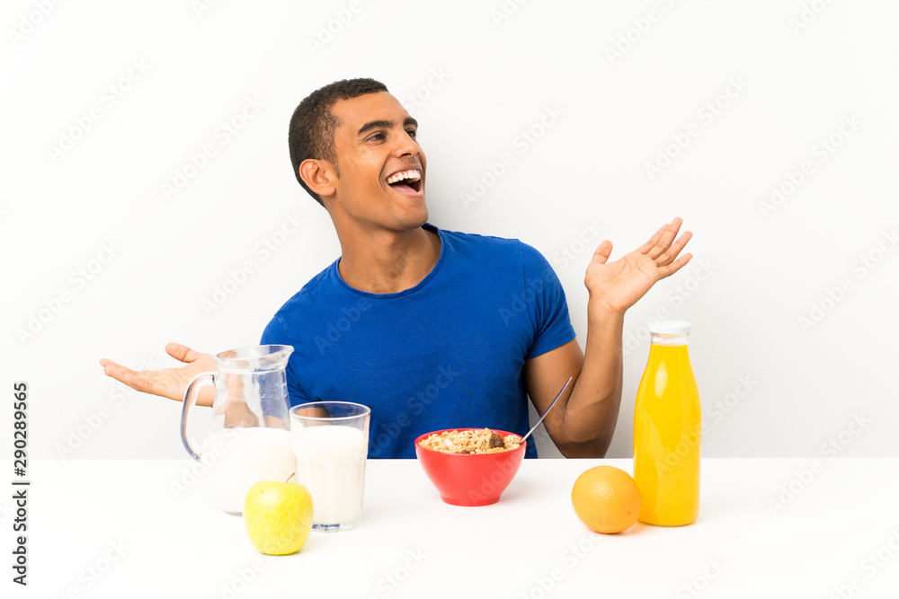 Young man having breakfast in a table with surprise facial expression Young man having breakfast in a table with surprise facial expression