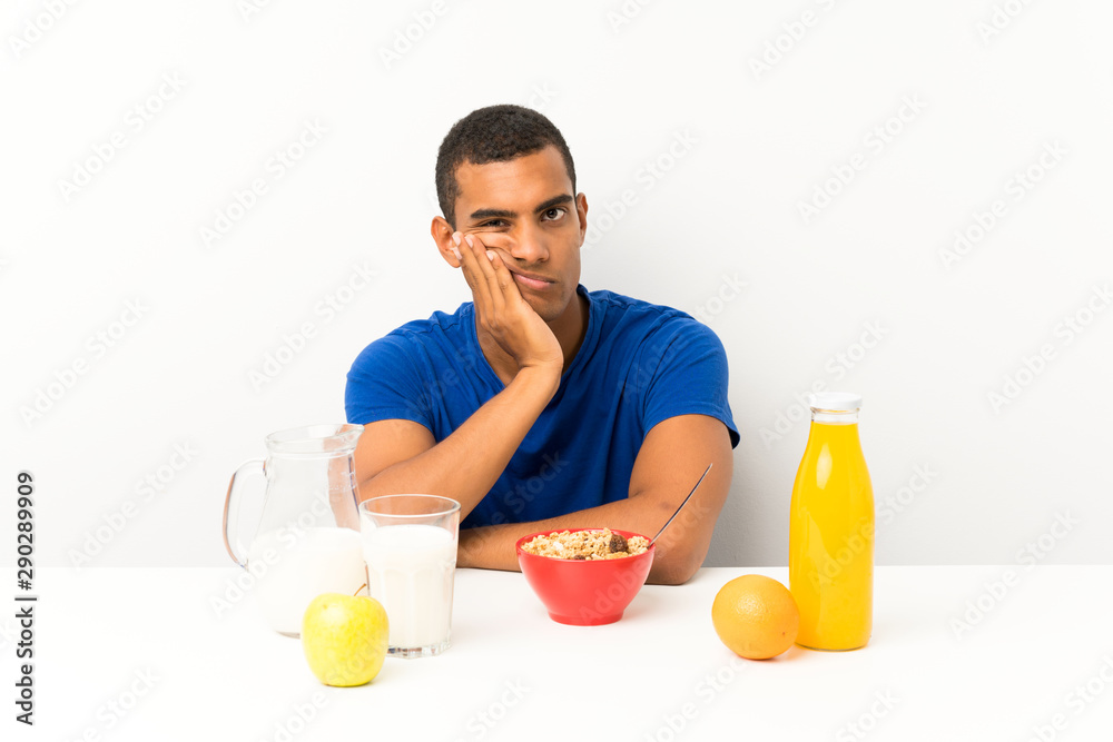 Young man having breakfast in a table unhappy and frustrated Young man having breakfast in a table unhappy and frustrated