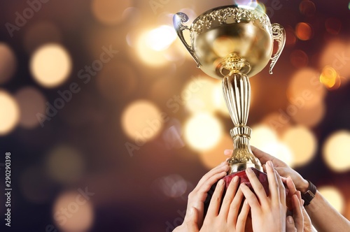 Hands holding a champion golden trophy on white background photo