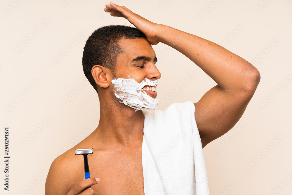 Young handsome man shaving his beard over isolated background has realized something and intending the solution