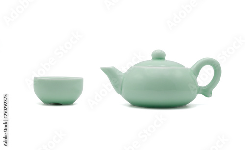 Chinese ceramic green teapot and teacup isolated on white background, side view photo.