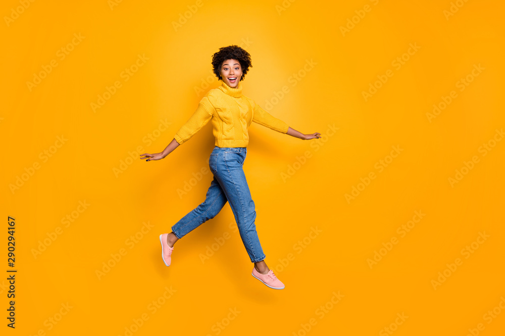 Full length body size photo of cheerful charming cute nice glad girlfriend walking lightly jumping running wearing jeans denim pullover isolated vibrant color background