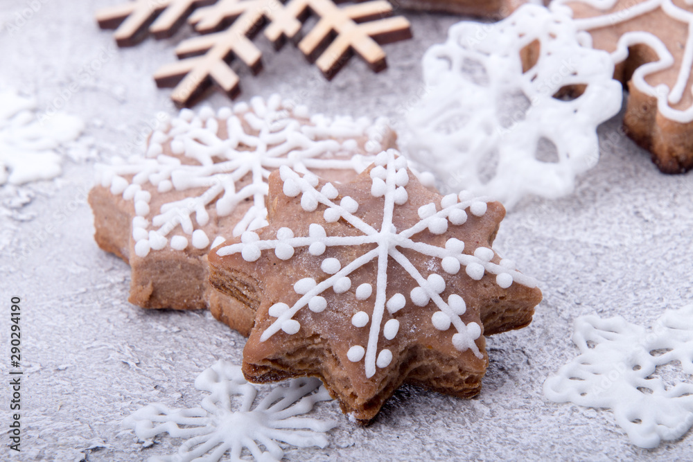 Christmas New Year gingerbread cookies snowflakes on sugar powder background. Christmas New Year gingerbread cookies snowflakes on sugar powder background.