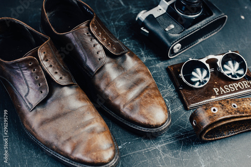stylish leather accessories, brown shoes, a camera, a passport, sunglasses. Travel concept © velimir