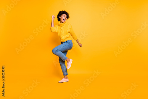 Full length body size view of her she nice attractive cheerful cheery content successful wavy-haired girl having fun free time rejoicing isolated on bright vivid shine vibrant yellow color background