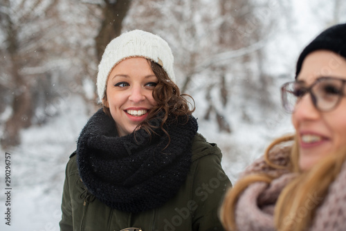 Young smiling woman in a park, on a winter day