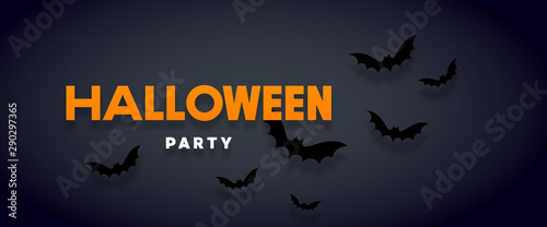 Halloween holiday background with bats flying over orange background. Halloween concept. Flat lay