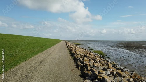 POV driving over the Schiermonnikoog dike next to the low tide Waddensea photo