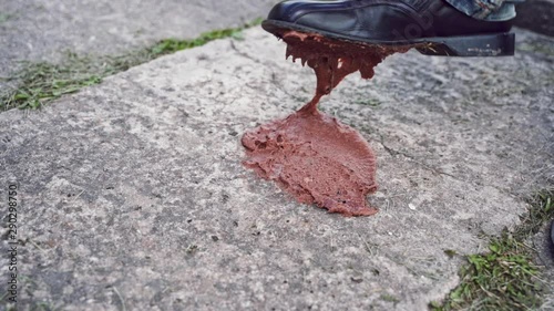 Poop is hanging from shoe outsole. A man is trying to clean his dirty outsole of a shoe and is depressed that shit does not come off. SLOW MOTION