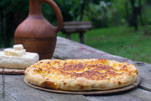 Traditional Georgian food khachapuri on the wooden table photo