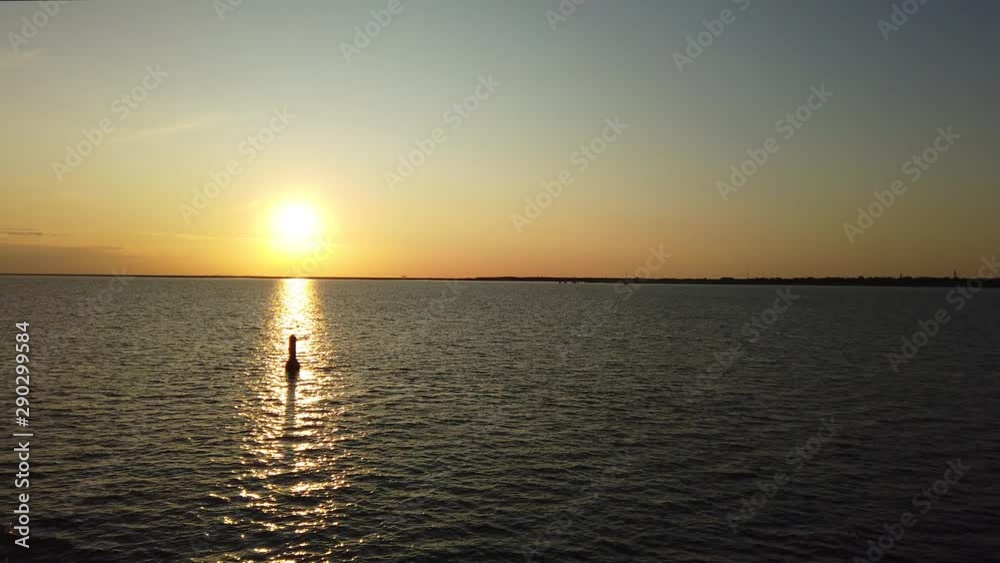 Sunset at Wadden sea dolly shot taken from the ferry along some buoys Sunset at Wadden sea dolly shot taken from the ferry along some buoys