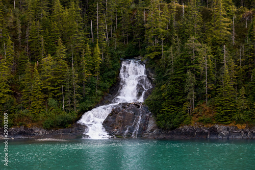  Beautiful flowing waterfall into the ocean in Endicott Arm fjord near Juneau Alaska photo