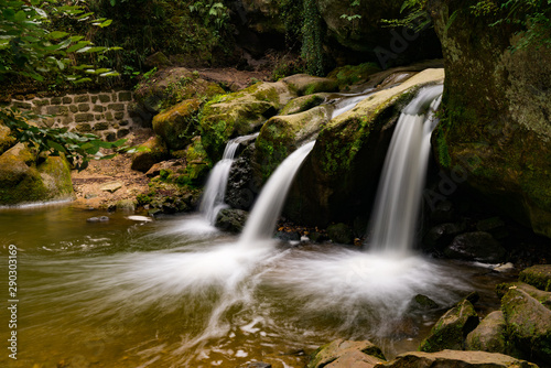 Fototapeta Naklejka Na Ścianę i Meble -  idyllic small waterfall in lush green forest landscape