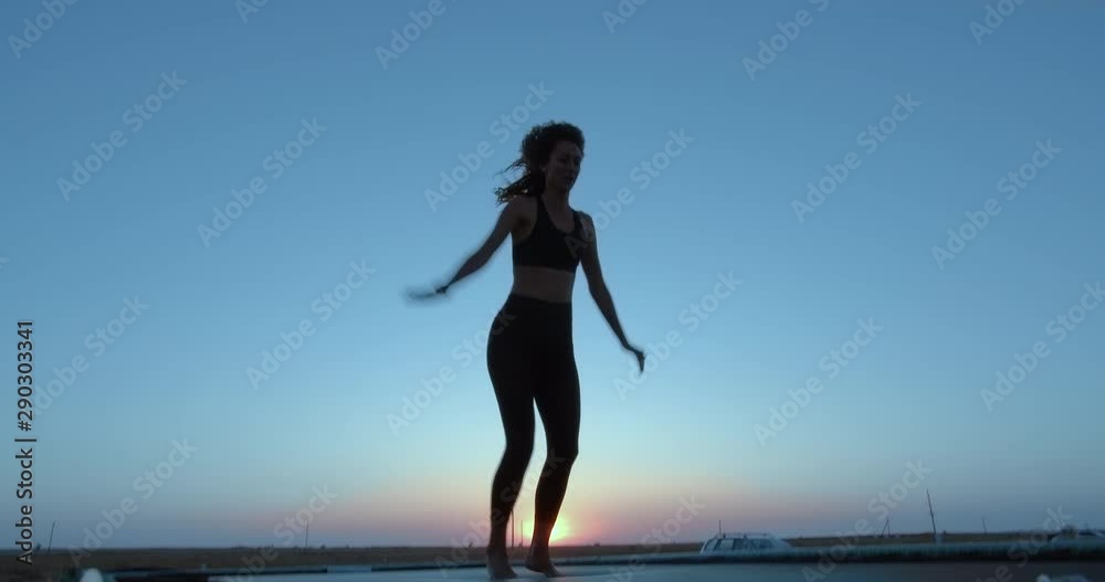 A girl jumps high on a trampoline. Against the sky. Active lifestyle. A girl jumps high on a trampoline. Against the sky. Active lifestyle.