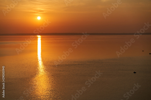 Dawn early in morning over wide long Volga river