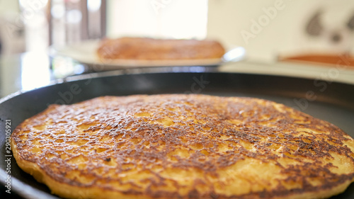 cachapas on a hot plate being prepared. corn pancakes photo