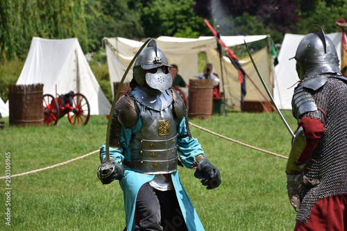 Medieval knight fighting with sabres. Historical reenactment in Brodnowski park in Warsaw, Poland
