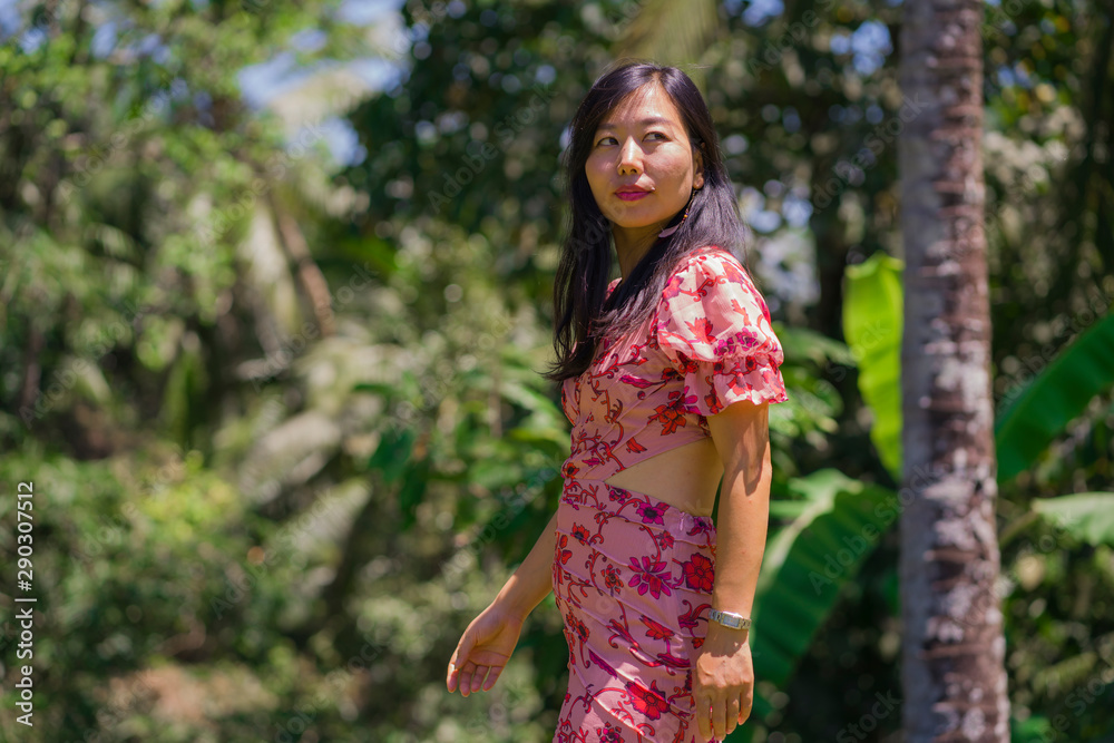 outdoors Summer lifestyle portrait of young beautiful and happy Asian Korean woman in elegant dress walking tranquil and cheerful in green city park or wood outdoors Summer lifestyle portrait of young beautiful and happy Asian Korean woman in elegant dress walking tranquil and cheerful in green city park or wood