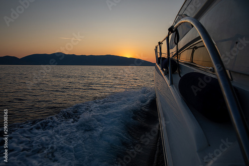 Traveling by yacht at sunrise time in the Ionian Sea, Kefalonia island, Greece.