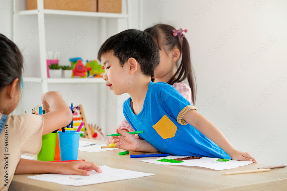 Children playing with friend in playroom at school