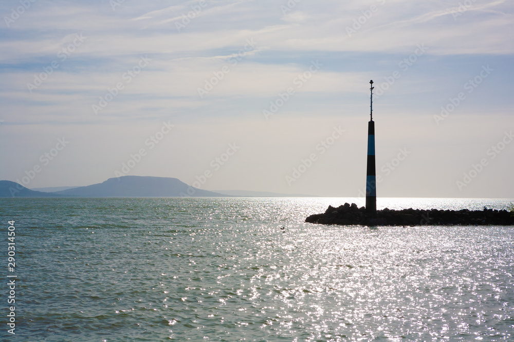 Lake Balaton, pier with beacon and the Badacsony mountain in the background