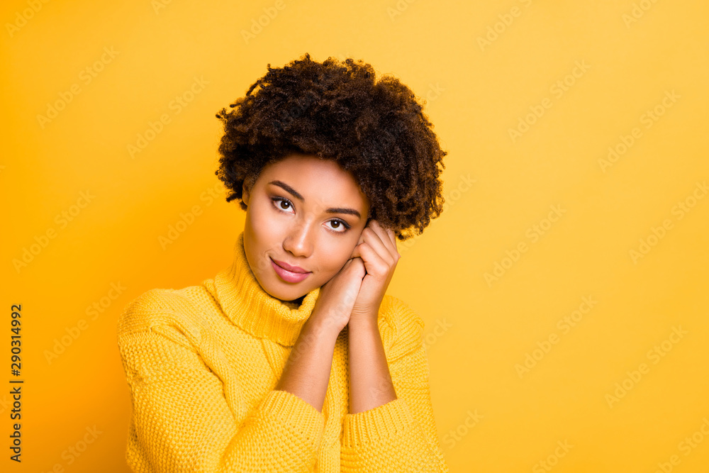 Photo of pretty dark skin lady dreaming holding hands near head wear warm knitted sweater isolated yellow color background Photo of pretty dark skin lady dreaming holding hands near head wear warm knitted sweater isolated yellow color background