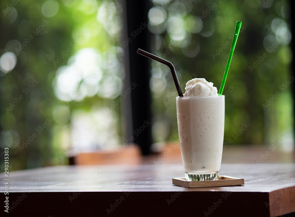milkshake on wooden table and copy space green bokeh nature , drink and beverage concept. milkshake on wooden table and copy space green bokeh nature , drink and beverage concept.