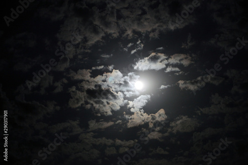 Black night sky with moon and clouds. Nature background.