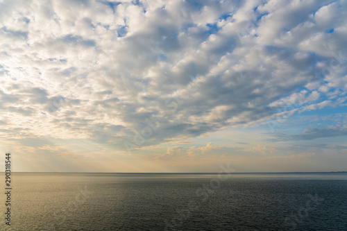 Sun light through the sky blast over the sea